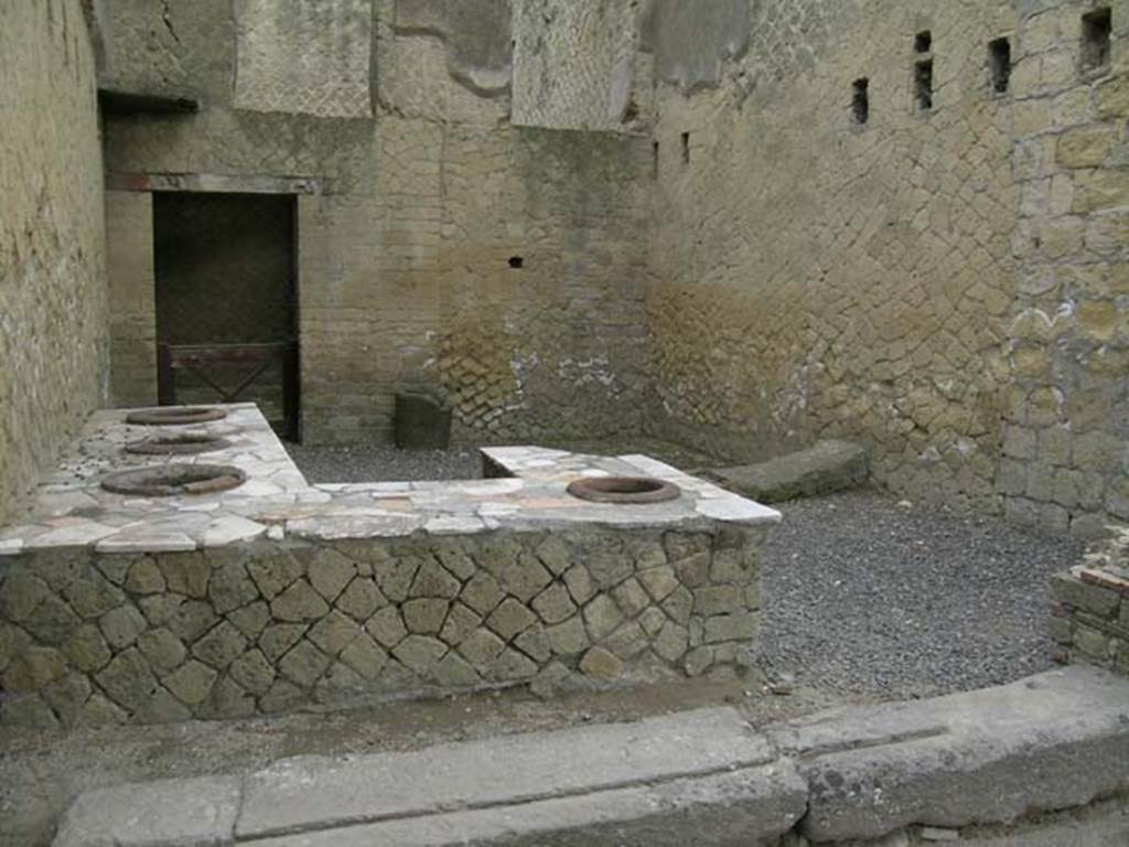 Ins Or II, 6, Herculaneum. June 2006. General view across counter, looking south-east.
The stairs leading to the upper floor would have been against the south wall.
The latrine would have been situated in the south-west corner, behind the brick wall, on right.
Photo courtesy of Nicolas Monteix.